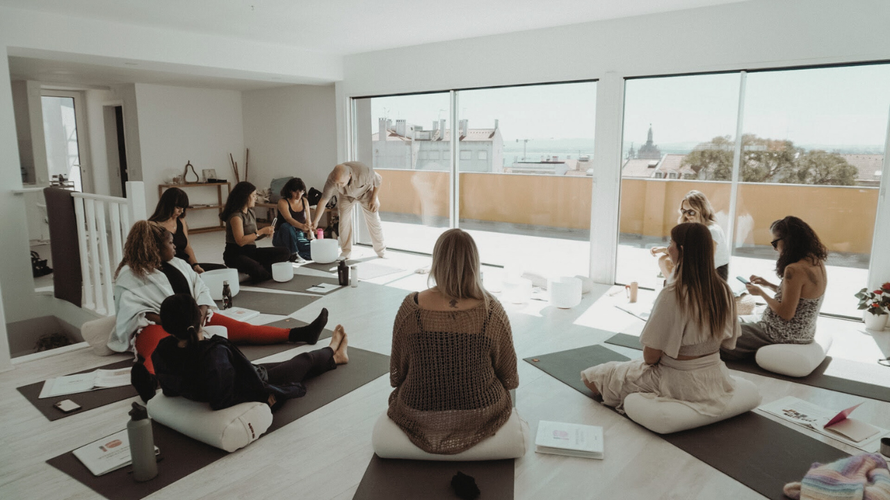 students participating in sound healer training with crystal singing bowls in a group workshop
