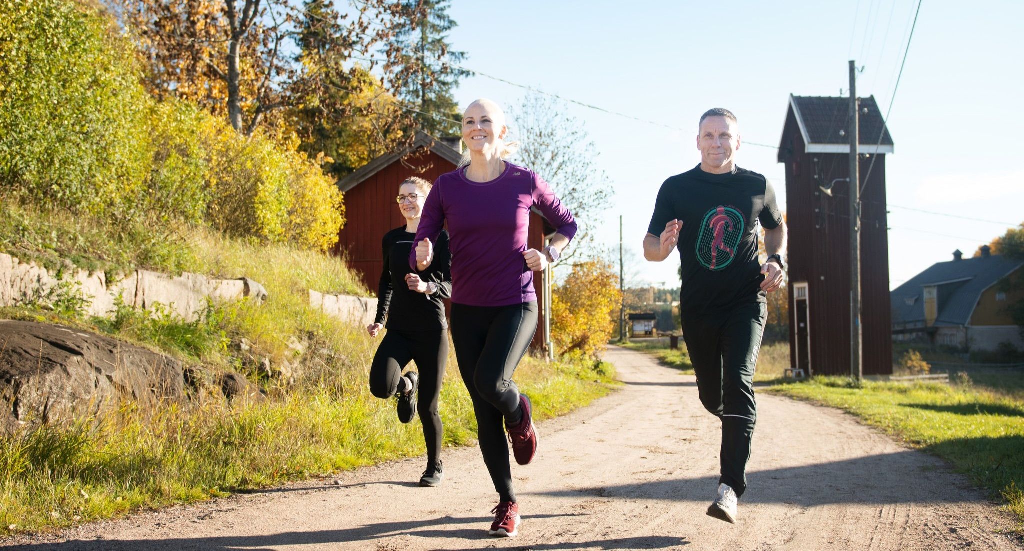 Group of runners training outdoors on a rural road in Finland
