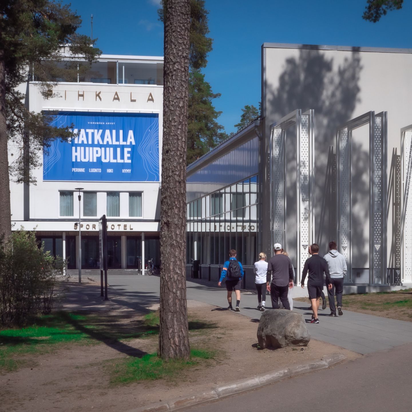 Sports center building surrounded by forest