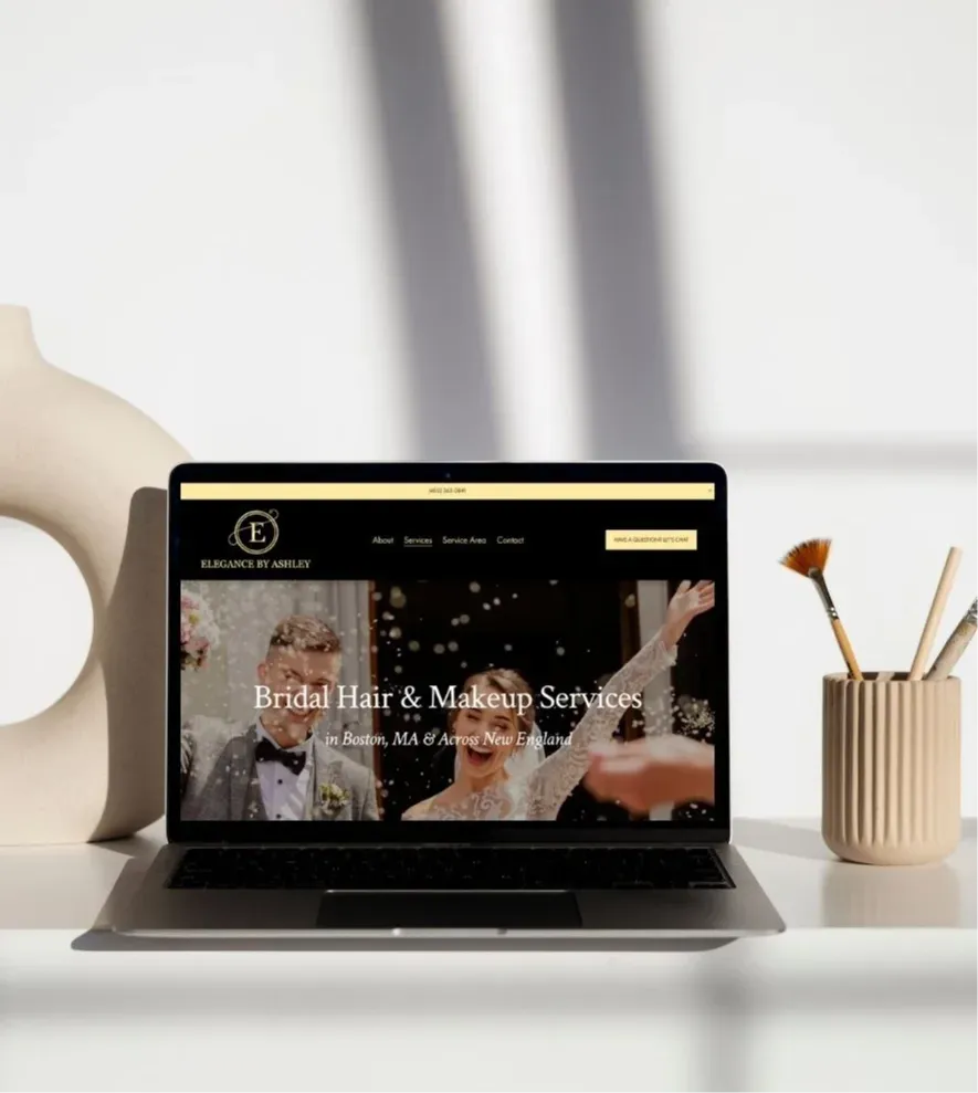 Laptop displaying custom website design for bridal hair and makeup services created by K+C Creative, shown in modern, minimal workspace setting.