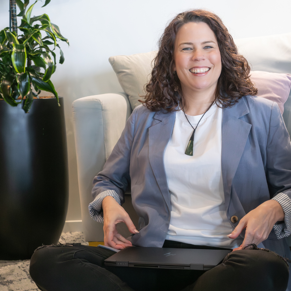 Sam Browne sitting in front of laptop