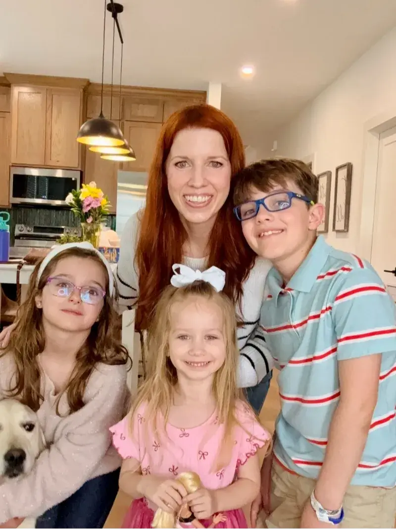 Carrie Howard with her 3 kids and dog in house