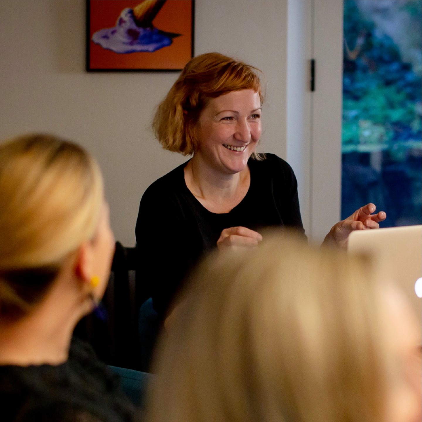 Photo of Emma Dempsey - smiling woman with auburn bobbed hair in dark top