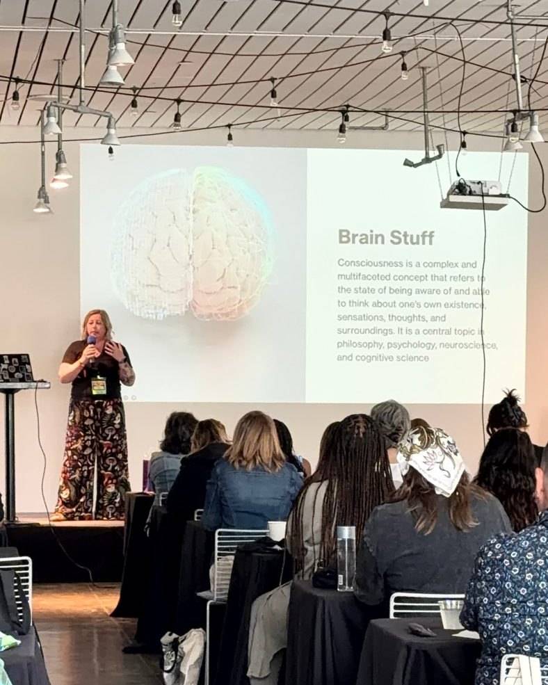 Becca Gerlach presenting a Brain Stuff slide on consciousness to a room of therapists at a conference training