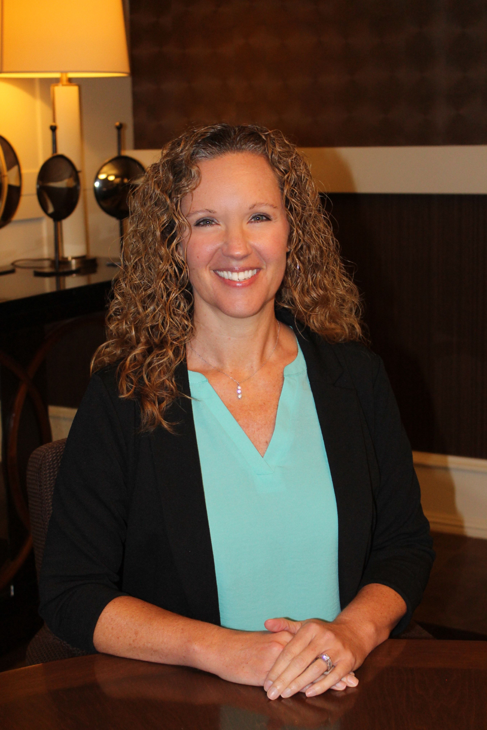 headshot kelly fredricks woman standing in front of tree