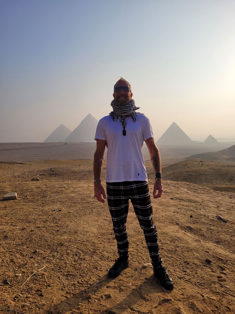 Jason Donaldson, MA, Galactic Shaman, standing before the Egyptian pyramids, symbolizing ancient wisdom and multidimensional healing.