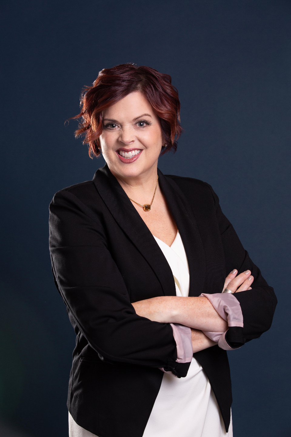 Dr Erika Salina in a copper blazer smiling at the camera