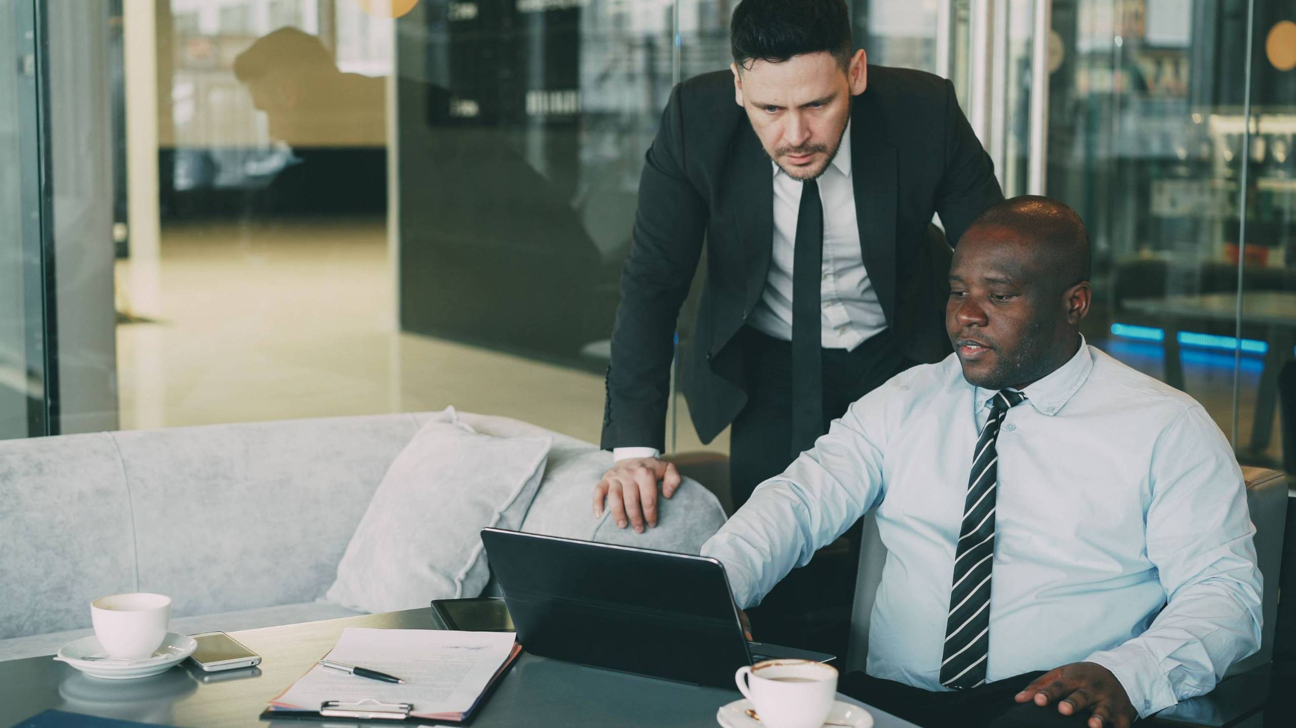 two business men looking at a laptop