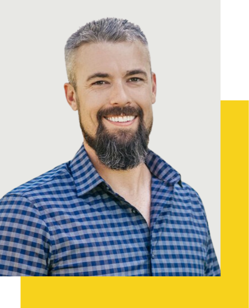 Man with gray hair and dark beard with a blue checked shirt