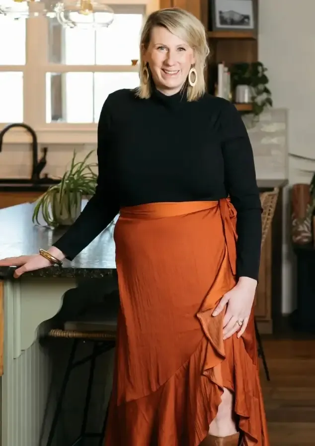 photo of katy poole in a kitchen standing with arm on counter