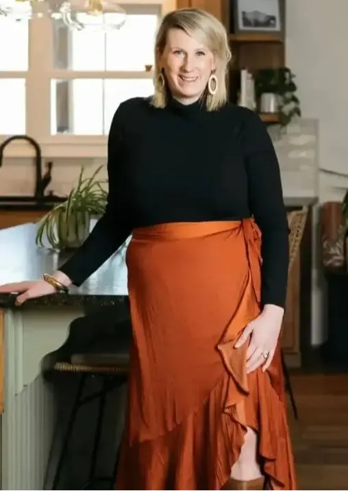 photo of katy poole in a kitchen standing with arm on counter