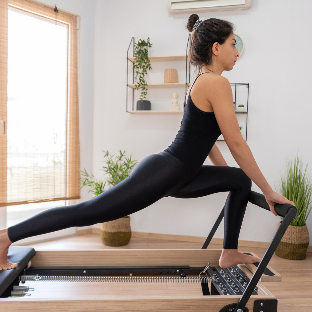 A young woman doing exercises on a blue yoga mat