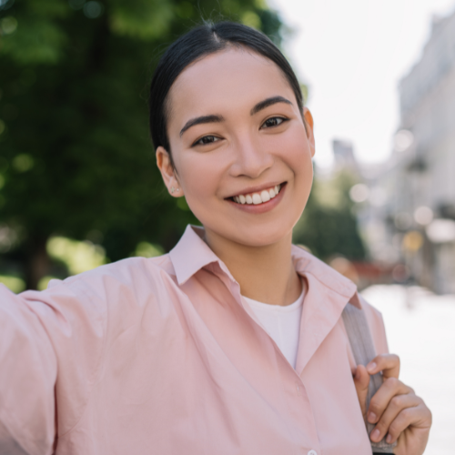 A smiling woman taking a selfie 