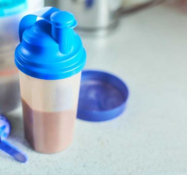 orange and lime slices with a branch of rosemary and a flavouring in a small glass bottle