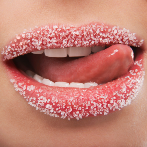 Womans' red lips covered in white sugar that causes blood sugar imbalances