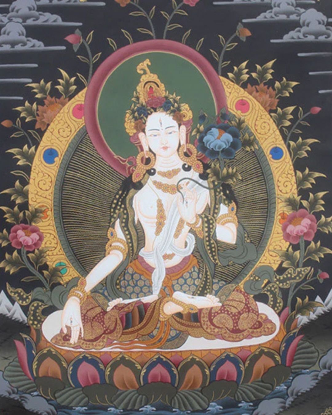 Traditional Tibetan thangka painting of White Tara, deity of compassion and longevity, depicted seated on a lotus throne with jewel ornaments against a dark background