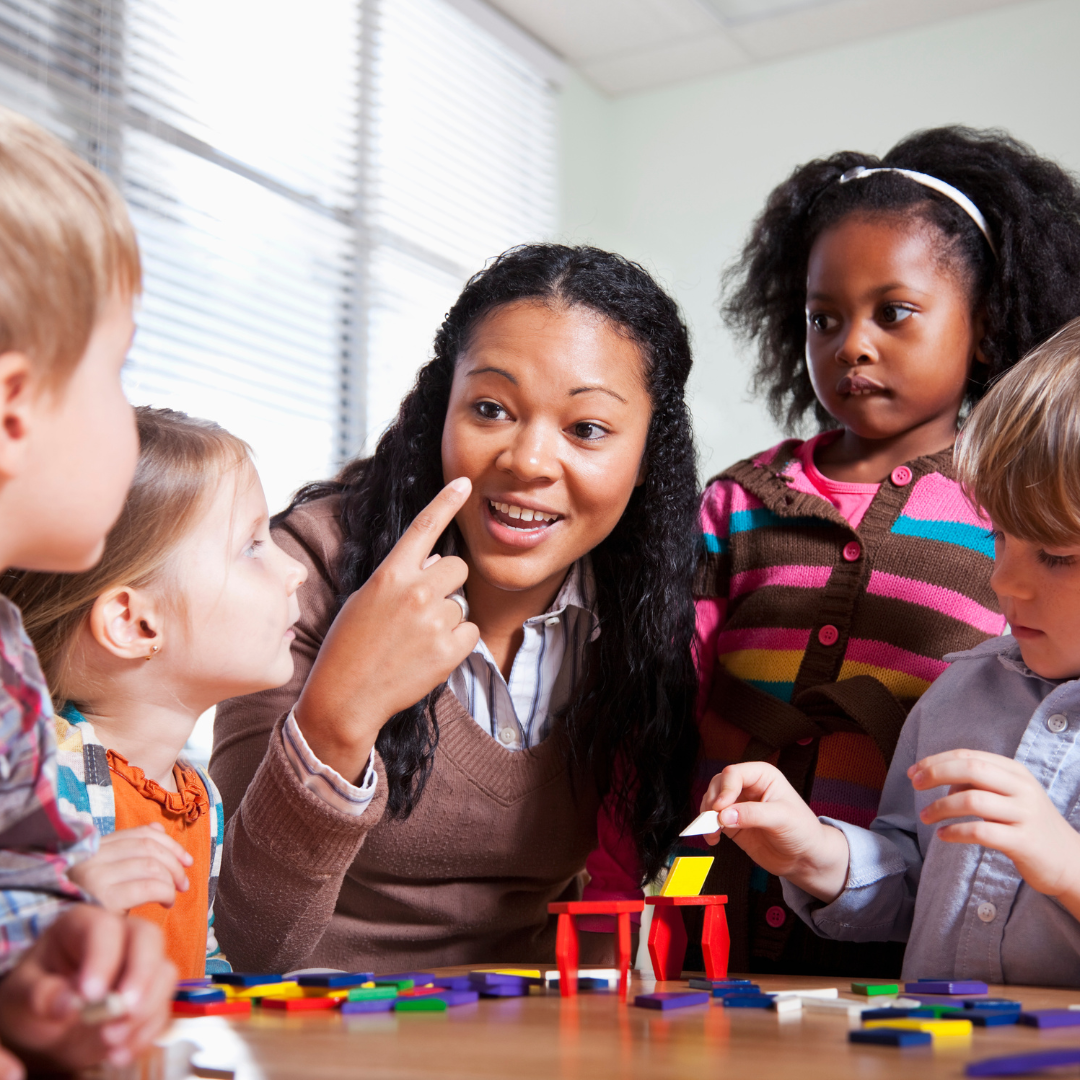 An image of a teacher talking to her students. 