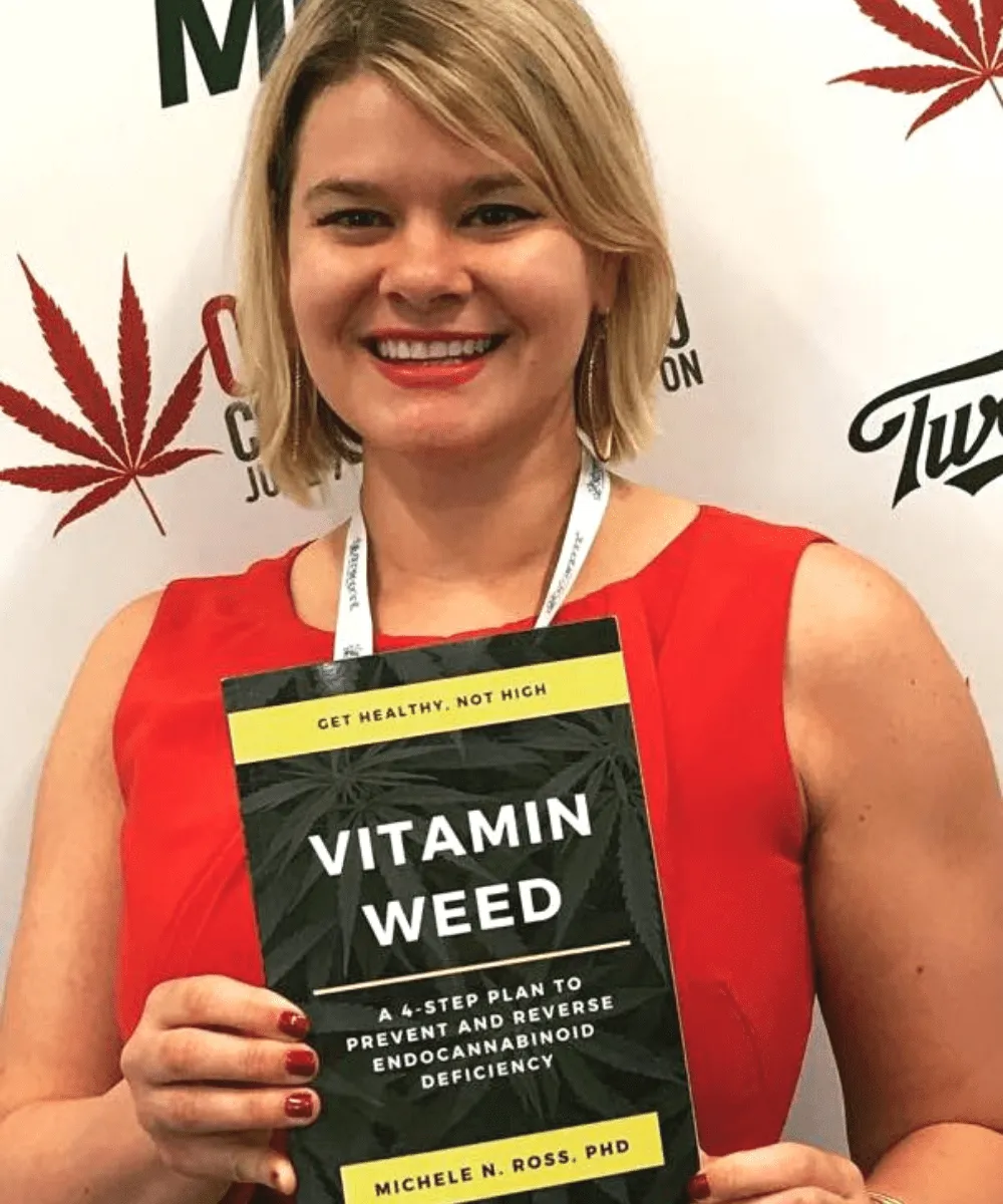Dr. Michele Ross holding her book Vitamin Weed
