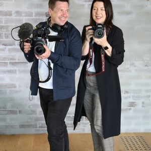 Sue Collins & Mike Hill holding cameras