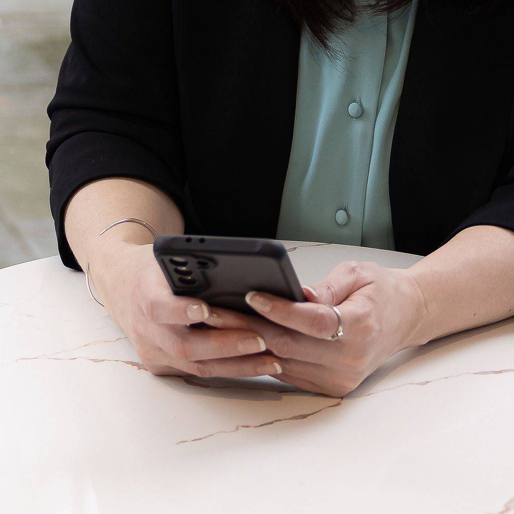 Close up of Kristyn Neal working on a cell phone