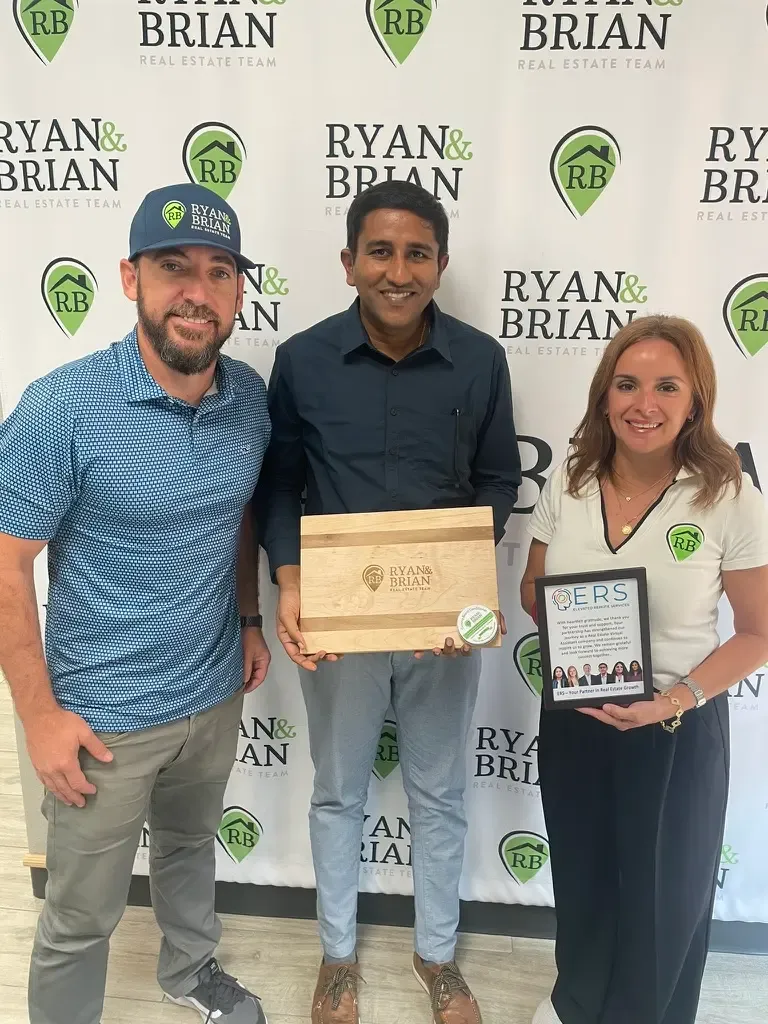 Suresh Rahul of ERS presenting momento to Ryan & Brian Real Estate Team in McAllen TX