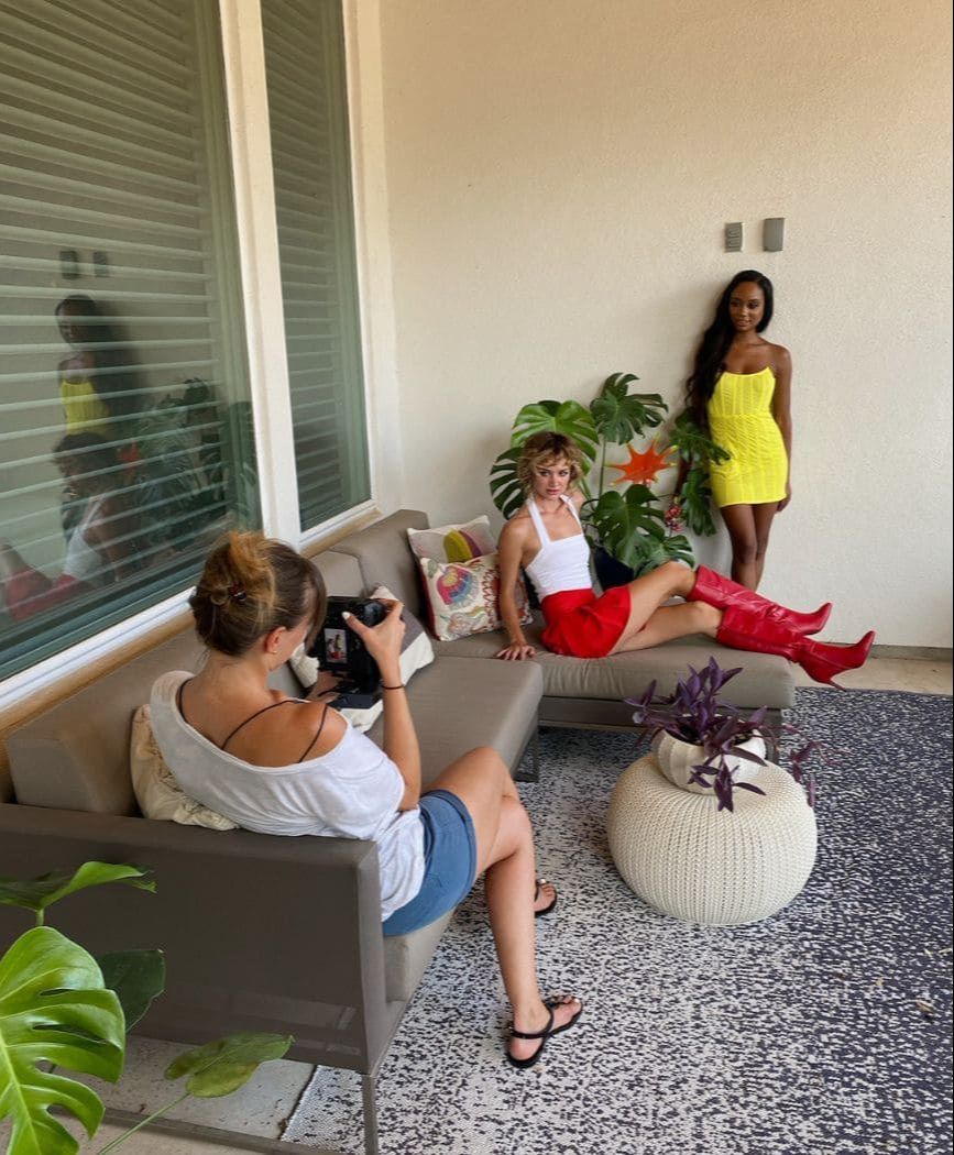 Vanessa Joy taking a photo of two models in day light