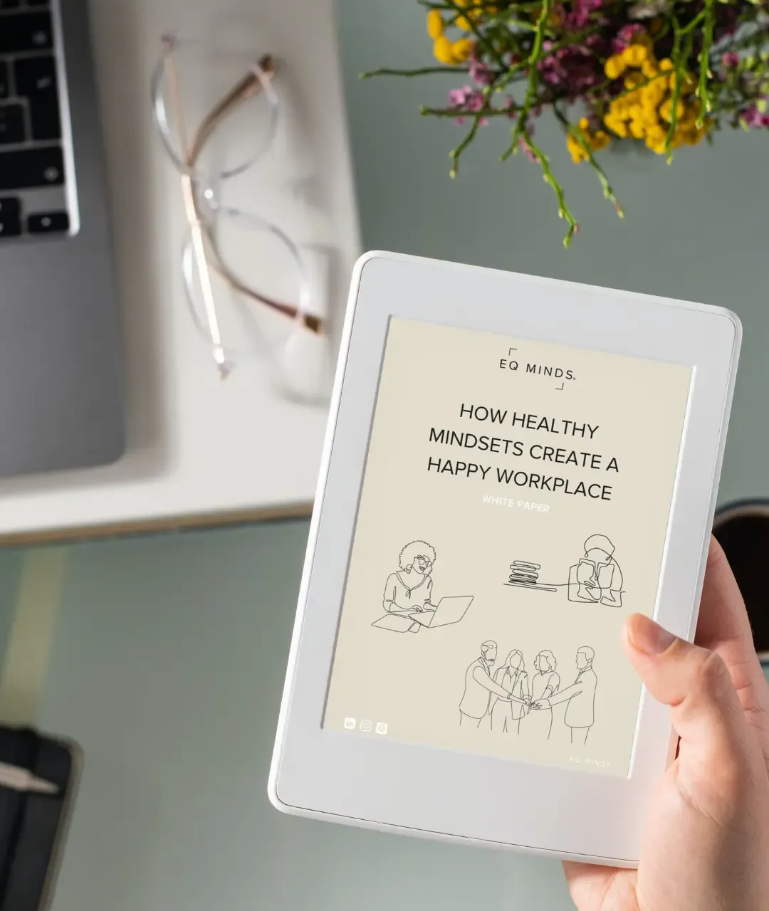 How healthy mindsets create a happy workplace white paper being read on an ipad