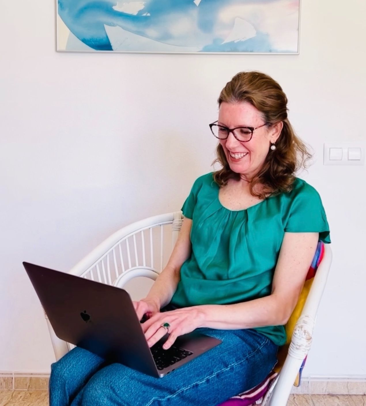 vanessa working on laptop sitting on chair