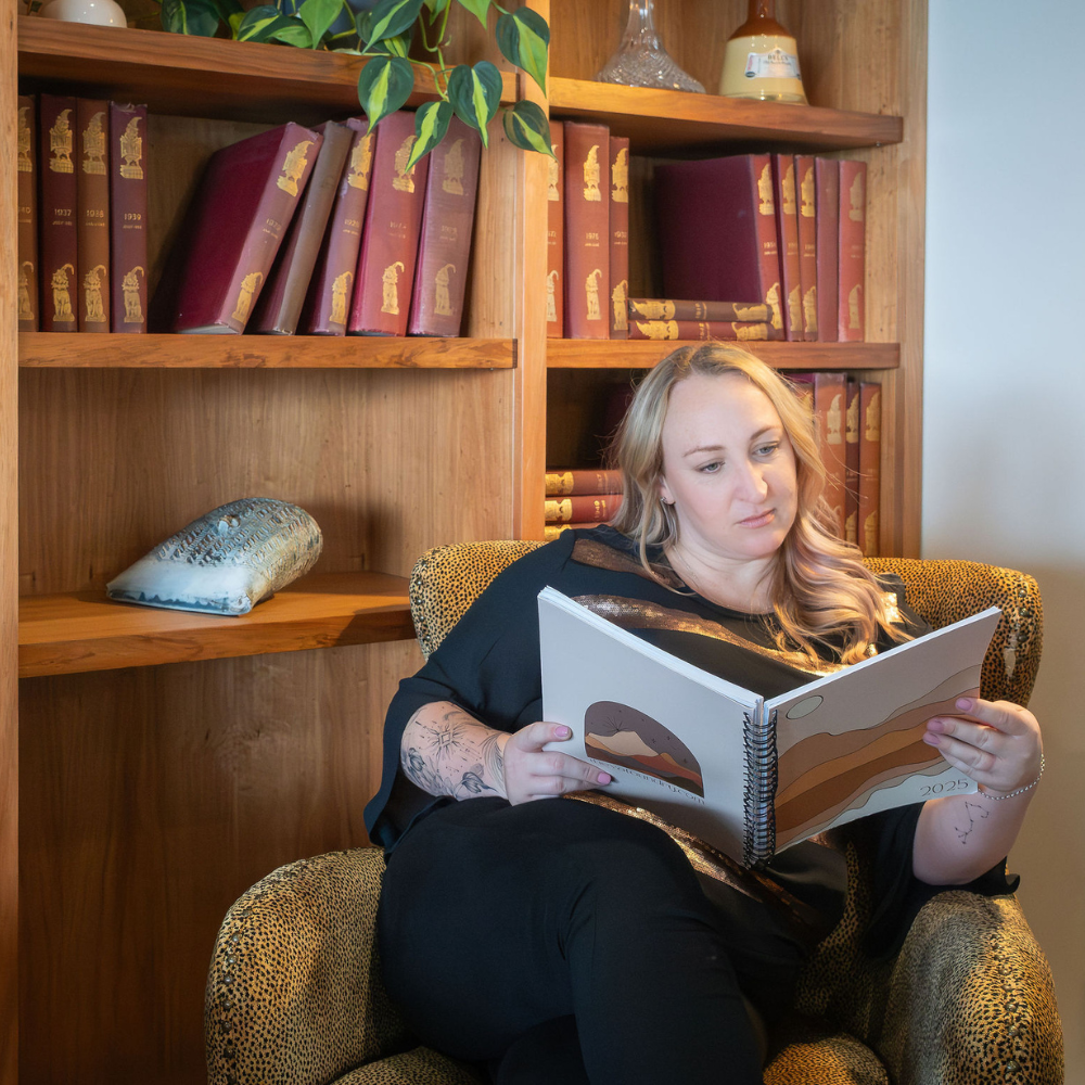 Toyah looking down reading a virtual assistant planner