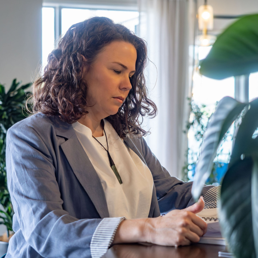 Marianne looking down reading a virtual assistant planner