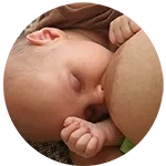 Close-up of a contented breastfeeding baby after successfully using The Thompson Method.