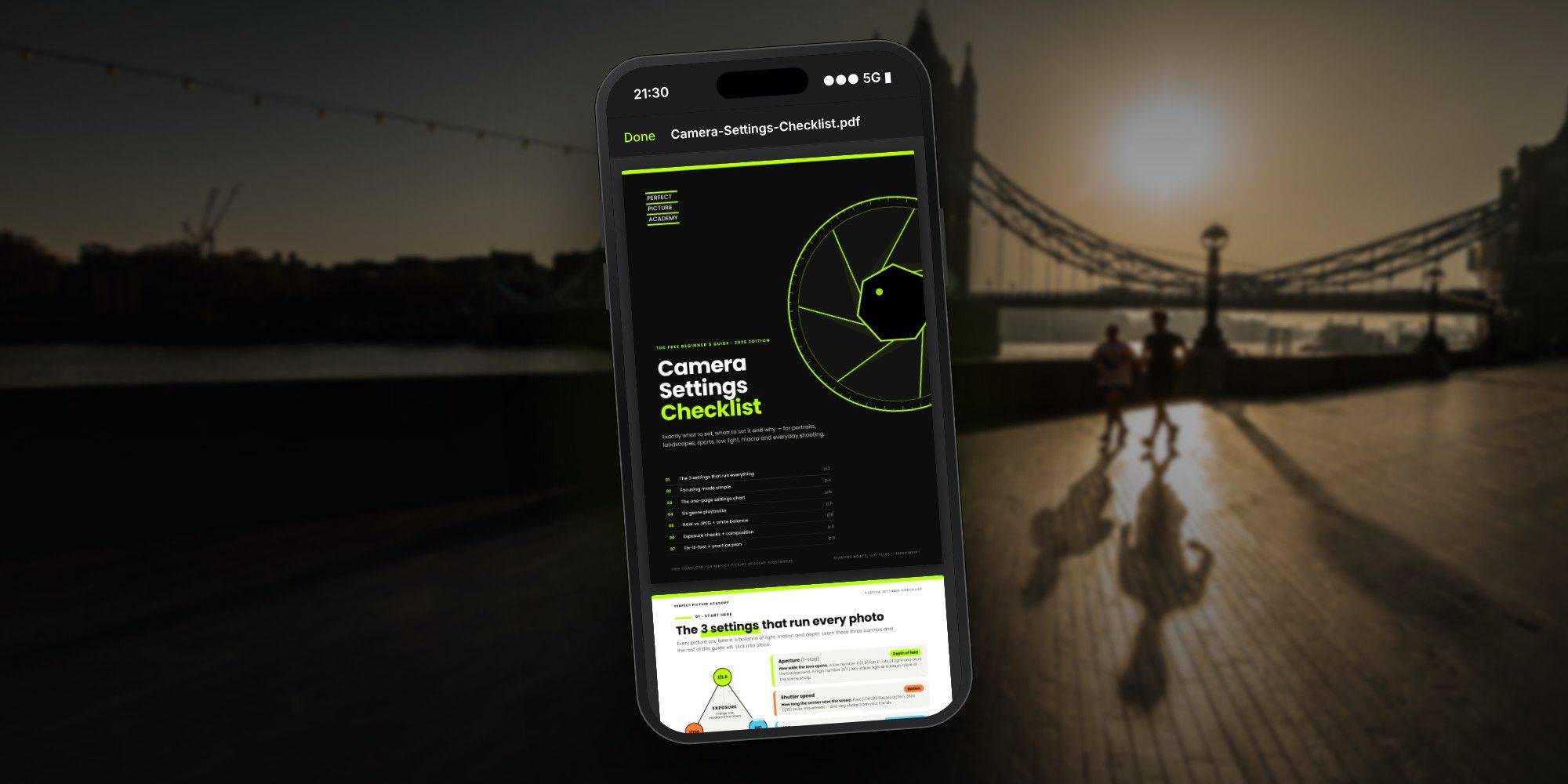 Camera Settings Checklist open on a phone, Tower Bridge at sunrise behind, by Mark Kaye