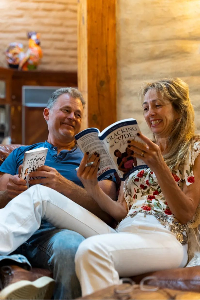 Tad and Kimberly Looking through their book together on a comfortable sofa