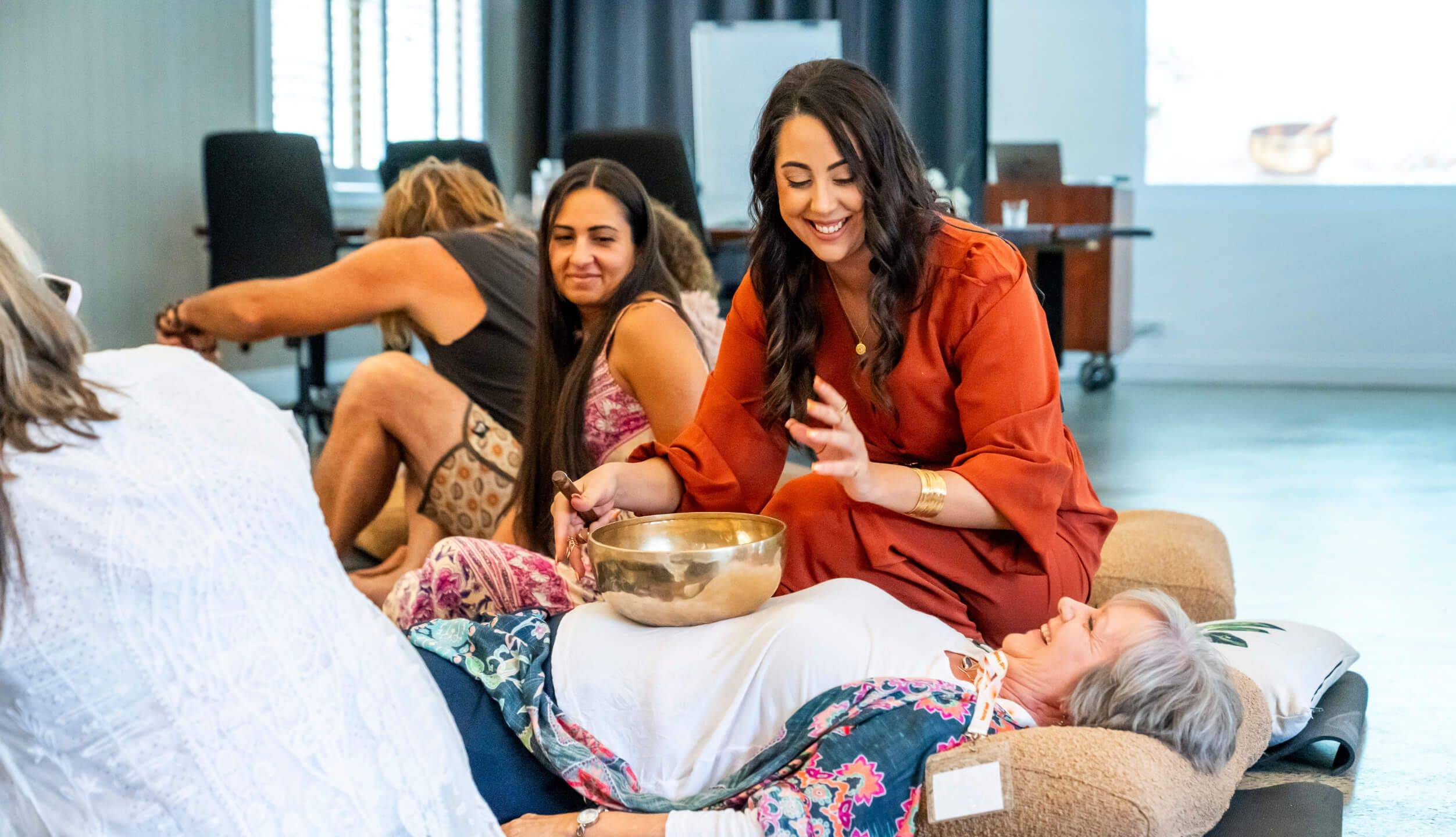 Student receiving sound healing therapy during accredited Sound Healing Practitioner Certification training