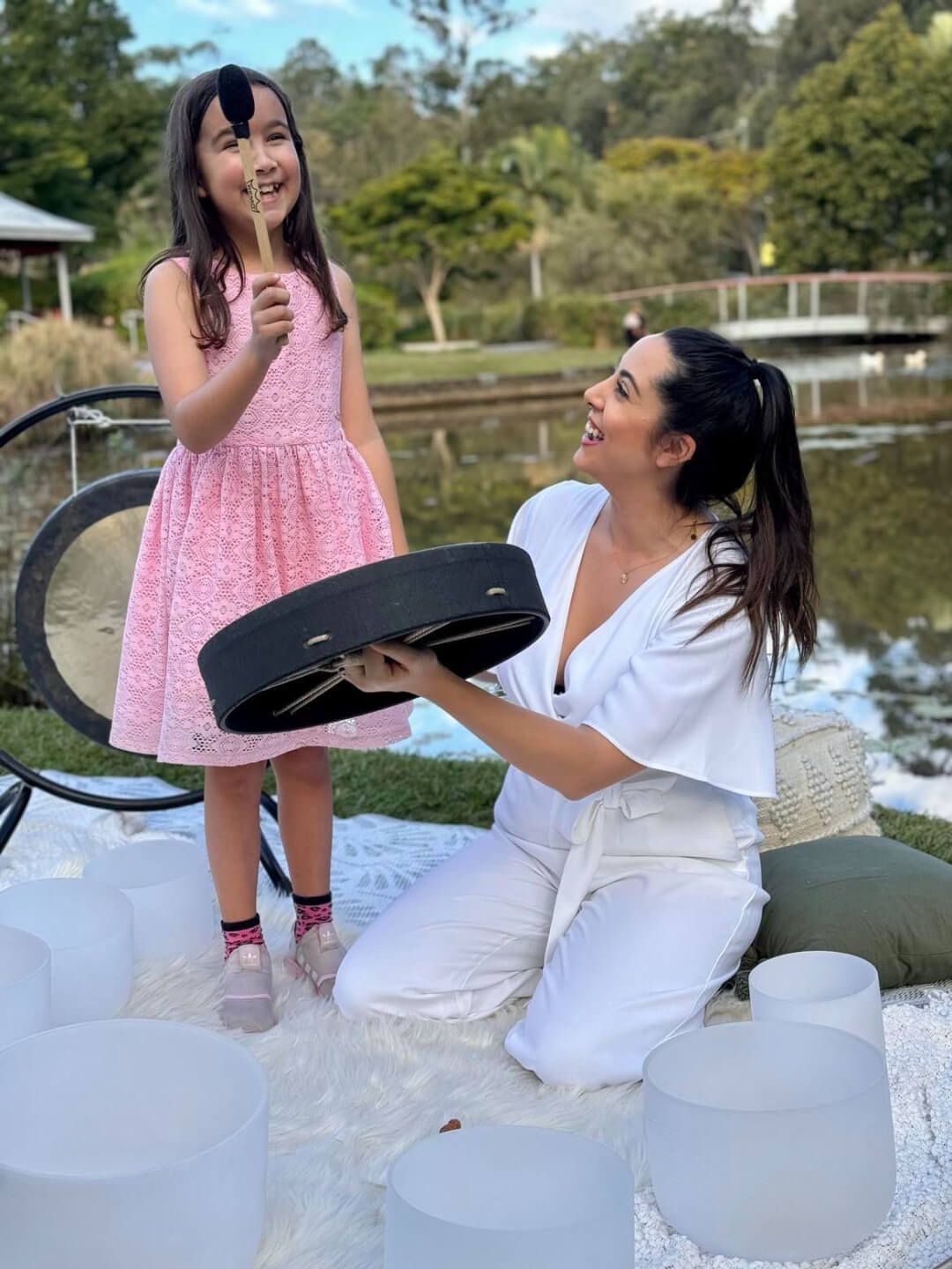 Sound healing practitioner using tuning forks for nervous system regulation with a child