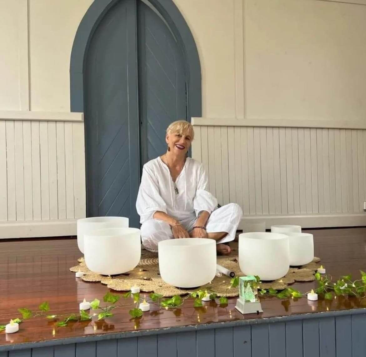 Sound healing instructor with crystal singing bowls ready for meditation and sound bath session