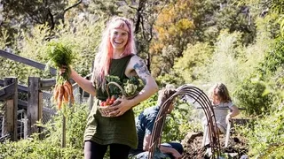 Hannah Moloney, organic gardening expert, harvesting fresh vegetables in her thriving permaculture garden - Learn organic vegetable gardening techniques in this comprehensive online course