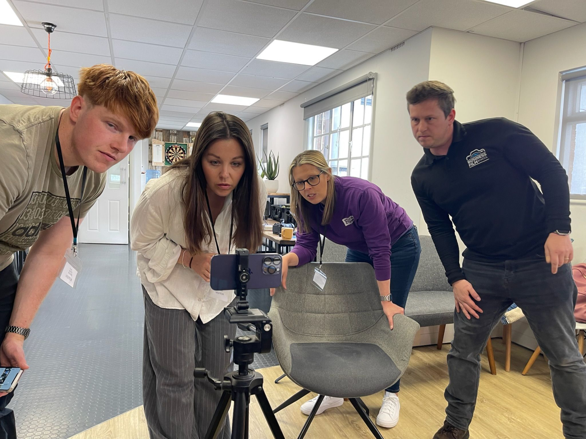 Workshop participant filming marketing content on a mobile phone during hands-on business video training.