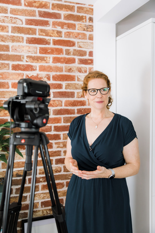 Rebecca Jabbar speaking in front of a camera