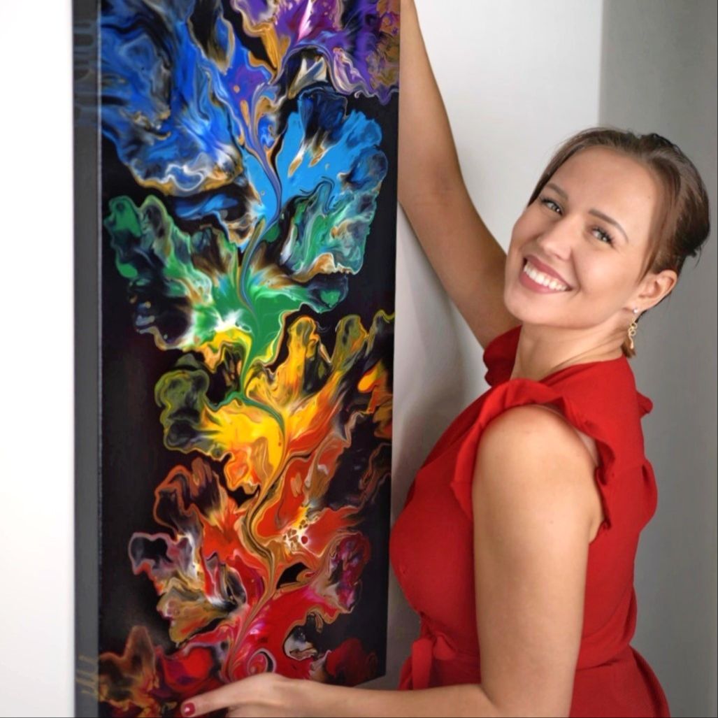 Female Artist Pouring Acrylic Medium For Painting Picture In Fluid