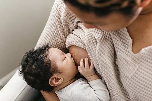 "Mother and baby share a special moment during breastfeeding - 5 star review"