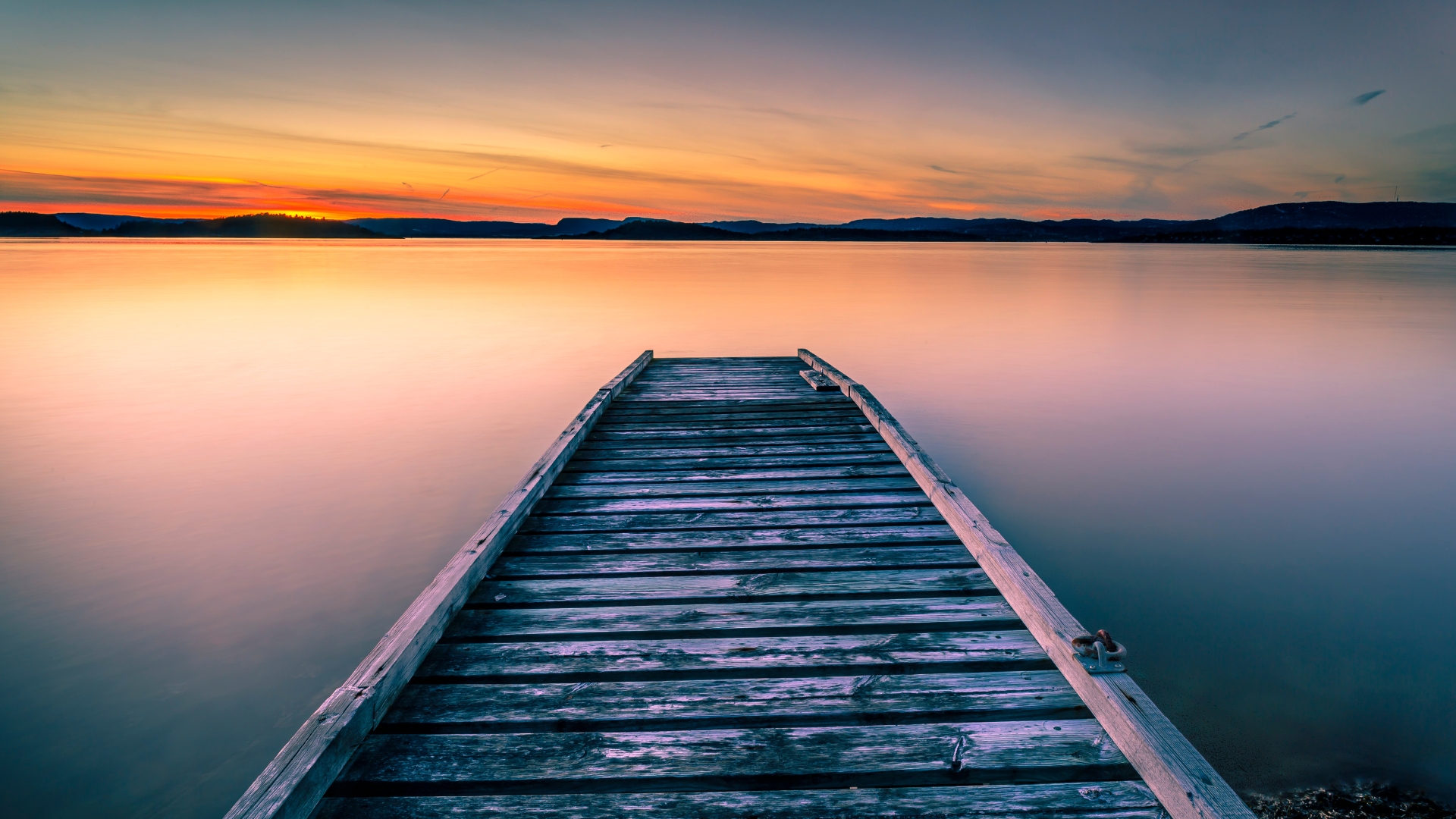 lake at sunrise with a dock to the water