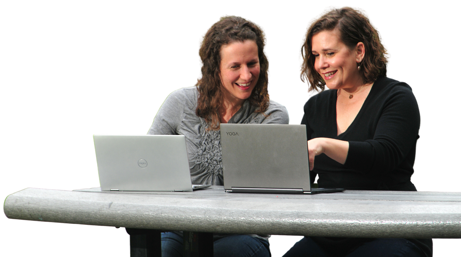 Jenn Lormand and Christina Walsh looking at laptops