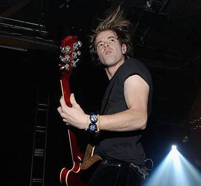 Shim Moore performing live with his red guitar