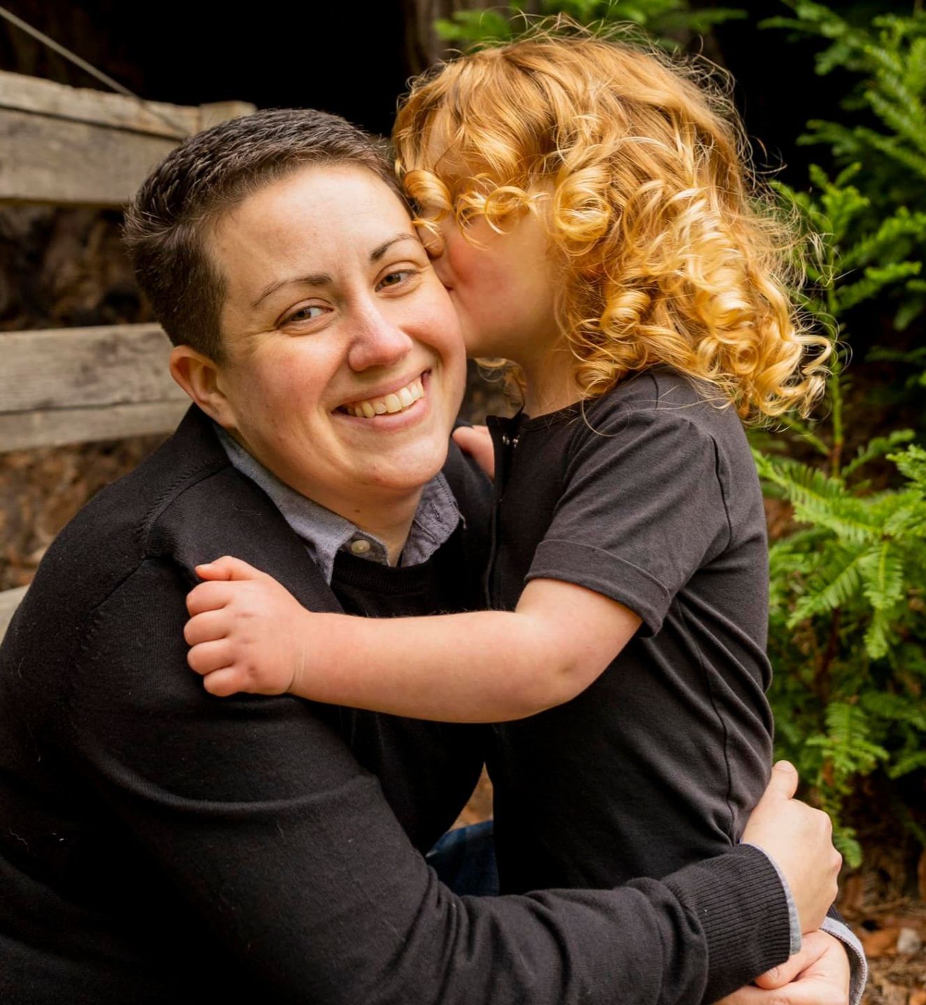 Parent Coach Ashley smiling with child