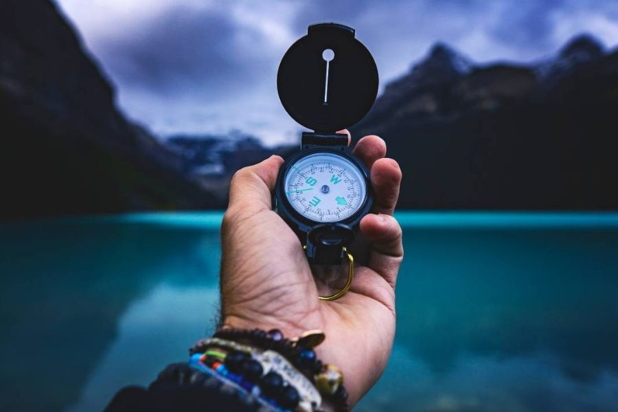 man holding compass