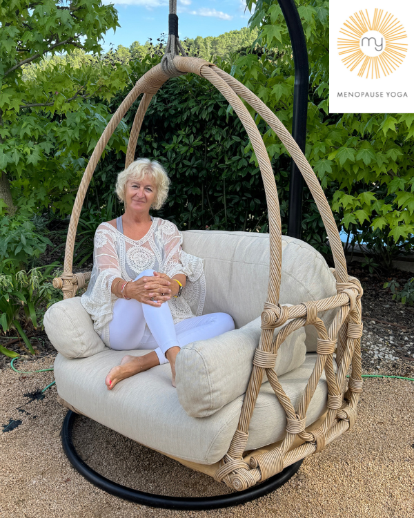 Head & shoulders of Julie Ann Garrido, founder of yoga for menopause membership arms folded wearing all pink