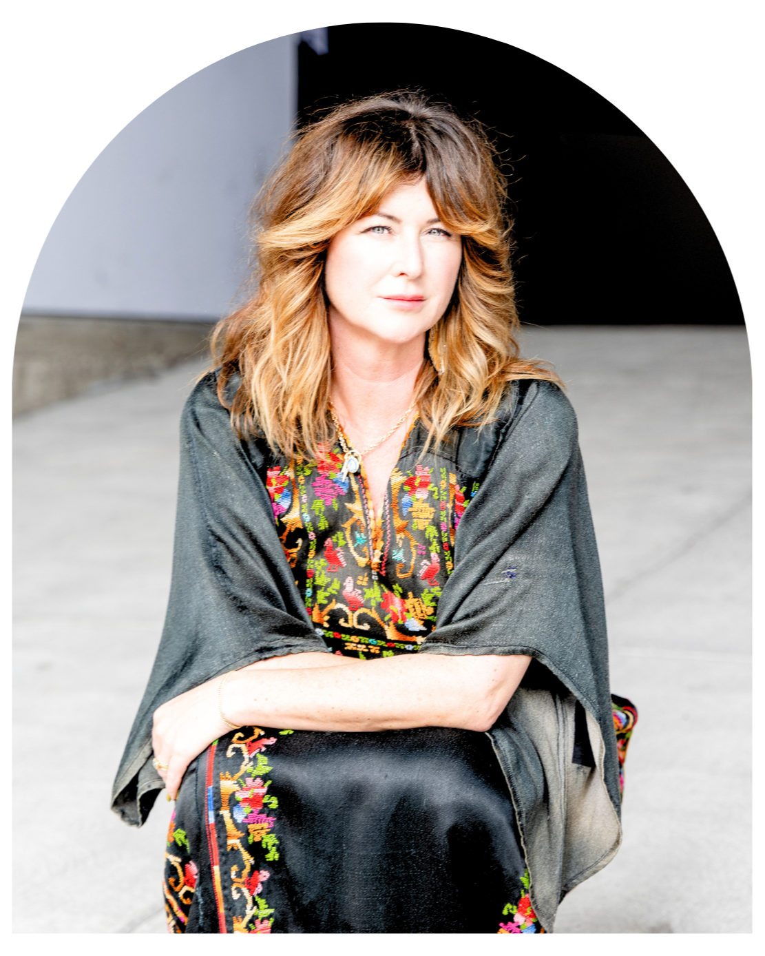 Mary Flocca Headshot with Black Blouse, Long Curly Brown Hair and Very Professional