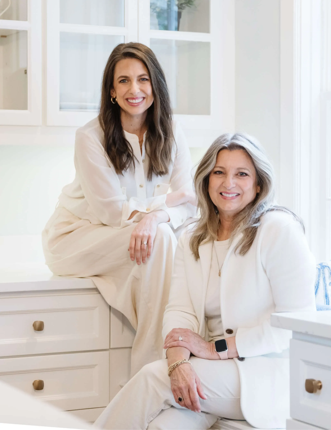 Staging Studio Co-Owners Andress Eichstadt, Debbie Boggs and Julie Young style a bed with pillows