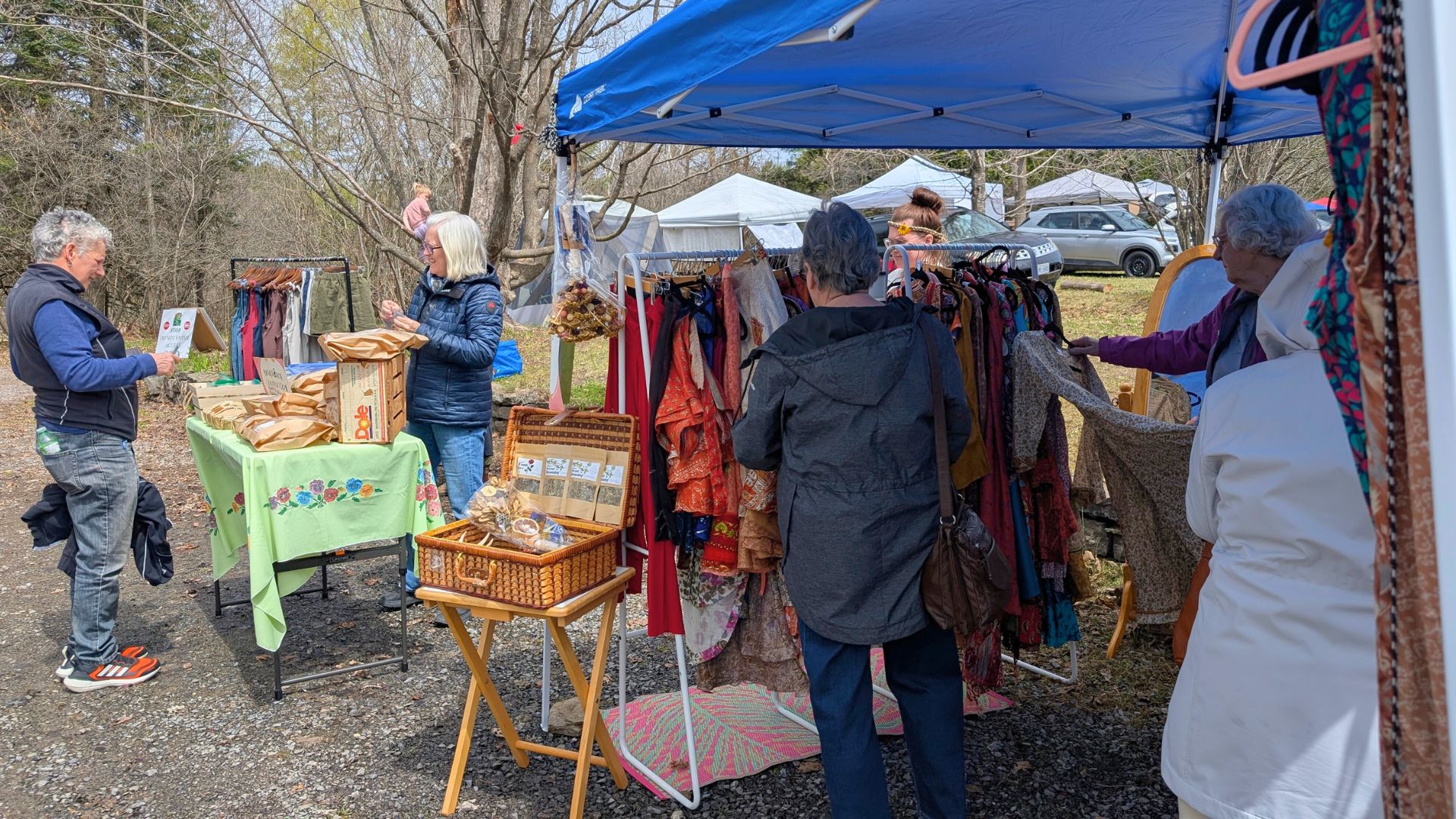 people browsing vendor stalls at an outdoor market